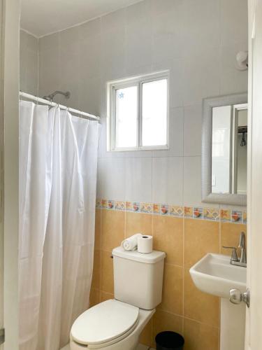 a bathroom with a toilet and a sink at Casa Coralina in San Carlos