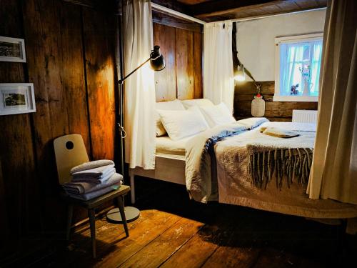 a bedroom with a bed in a room with a window at Lovingly Restored Half-Timbered House From 1684 in Großschönau