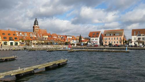 a city with a river and a pier and buildings at Apartment Yachthafen Waren in Waren