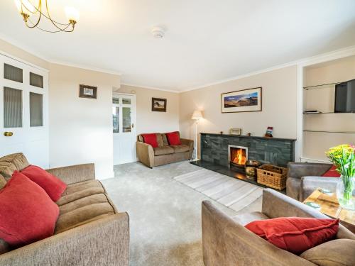 a living room with two couches and a fireplace at 2 Fairview Terrace Ambleside in Ambleside