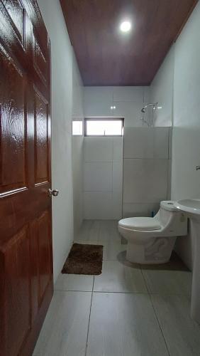 a bathroom with a toilet and a sink at SJO - Casa Taccari in Grecia