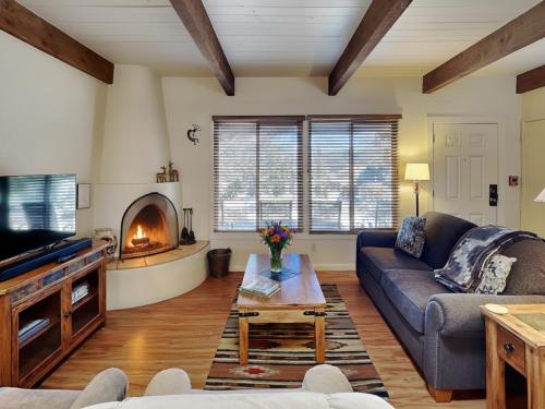 a living room with a couch and a fireplace at Artist Road #30 in Santa Fe