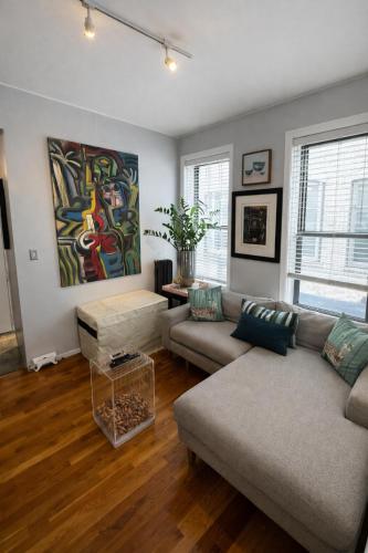 a living room with a couch and a table at Next to Manhattan 2 Bedrooms Apartment - Subway 20 steps, Manhattan 1 Stop in Roosevelt Island