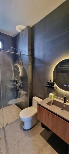 a bathroom with a toilet and a shower and a sink at Sis and Sea Villa in Haad Pleayleam