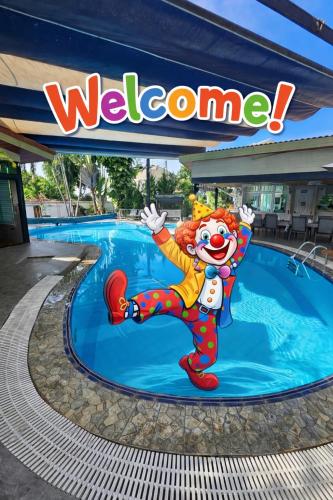 a sign for a water park with a clown in a pool at Separate house with swimming pool in Chiang Mai