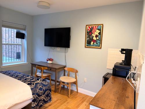 a bedroom with a bed and a desk with a computer at Sunny&Cozy Apartment in University City Walk to Drexel&Near UPenn in Philadelphia