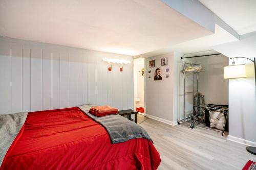 a bedroom with a red bed in a room at Updated Apt with Private Entry and FREE Parking in Washington, D.C.