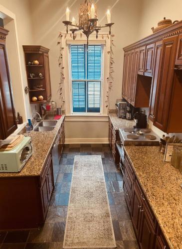 a large kitchen with a sink and a window at Historic- Salt Pool-Balconies-Near French Quarter in New Orleans