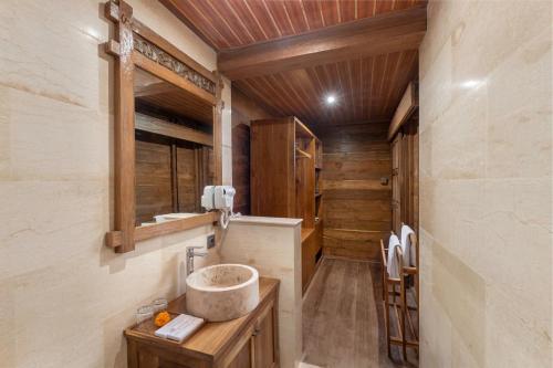 a bathroom with a sink and a wooden ceiling at Kirani House - Joglo Villa Bali in Darmasaba