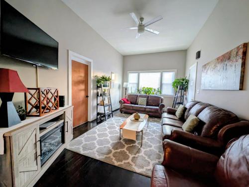 a living room with a couch and a flat screen tv at The Avondale Guesthouse in Chicago