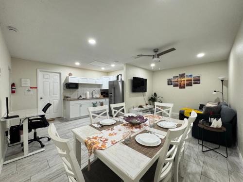a dining room and kitchen with a table and chairs at Sunshine Nest in Lehigh Acres