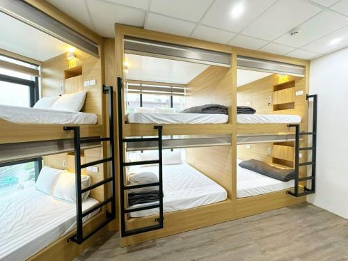 a room with four bunk beds in it at Ha Noi Capsule Station Hostel in Hanoi