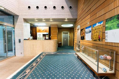 a lobby with a pool in the middle of a building at Hotel K Yuzawa 越後湯澤溫泉旅館 in Yuzawa