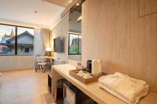 a kitchen with a counter with a sink in it at The Chedee Krungthep in Bangkok