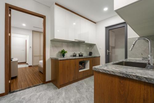 a kitchen with a sink and a counter top at Aravelle Suites managed by 22Land in Hanoi