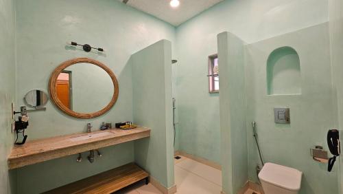 a bathroom with a sink and a mirror at Kadamb Bagh-A Luxury Nature Resort Sariska in Rāmsinghpura