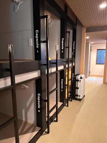 a locker room with a row of lockers and a suitcase at Artist Village Apartments Kochi in Kochi