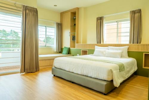 a bedroom with a large bed and a window at Reach Home Hatyai in Hat Yai