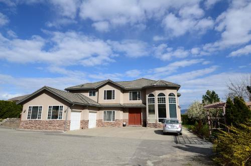 a house with a car parked in a driveway at 1 BDRM 1 BTH Suite with Private Entry in West Kelowna