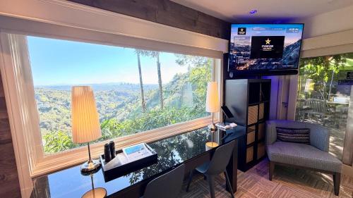 a room with a desk and a large window at HOLLYWOOD HILLS JETLINER VIEWS at STUDIO 1080 HOLLYWOOD in Los Angeles