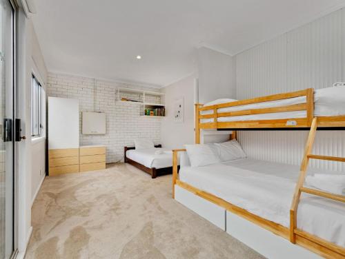 a small room with two bunk beds in it at Sea Side Glide at Maloneys Hide in Maloney's Beach