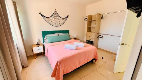 a bedroom with a bed with two towels on it at Casa amplia y privada con alberca para una escapada perfecta in Playa del Carmen