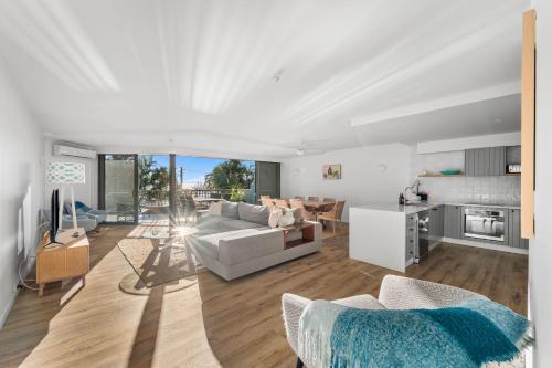 a living room with a couch and a kitchen at The Rocks Resort - Official in Gold Coast