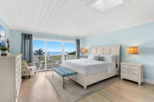 a bedroom with a bed and a view of the ocean at 1045 Wave Crest Avenue in Indialantic