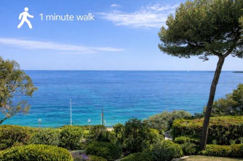 a picture of the ocean with a person running on the beach at Beachfront Villa Cannes I Garden - Terrace & Sea View -Prime Location- Free Parking in Cannes
