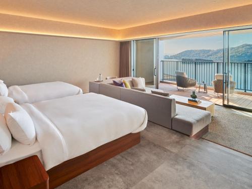 a hotel room with a bed and a balcony at edit x seven SETOUCHI SHODOSHIMA in Shodoshima