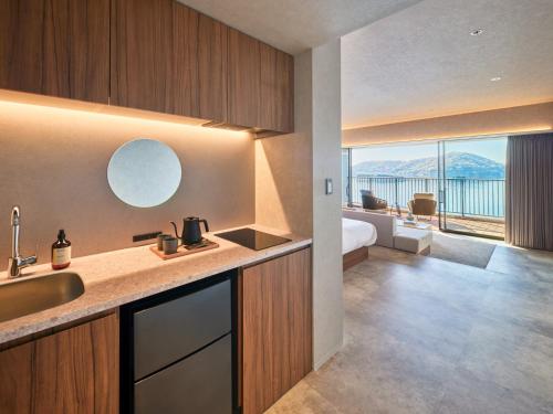 a kitchen with a sink and a bathroom with a view at edit x seven SETOUCHI SHODOSHIMA in Shodoshima