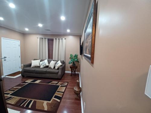 a living room with a couch and a rug at Nice Luxury Suite in Austell