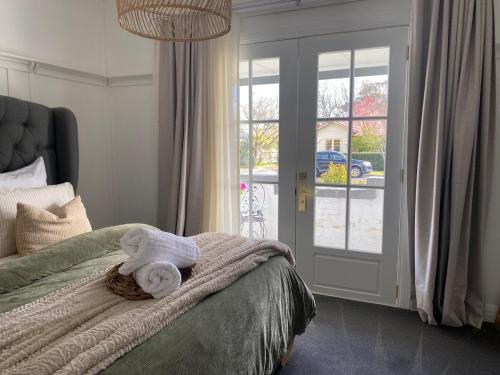 a bedroom with a bed with towels on it at Elegant 3br Haven with Character & Charm in Yarram