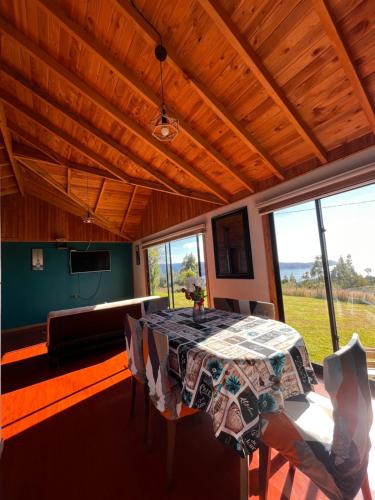 a dining room with a table and a couch at Cabaña arriendo Salome in Valdivia