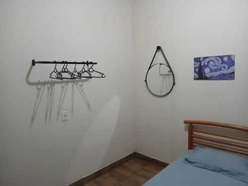 a bedroom with a bed and a mirror on the wall at Chácara pedacinho do paraíso in Cesário Lange
