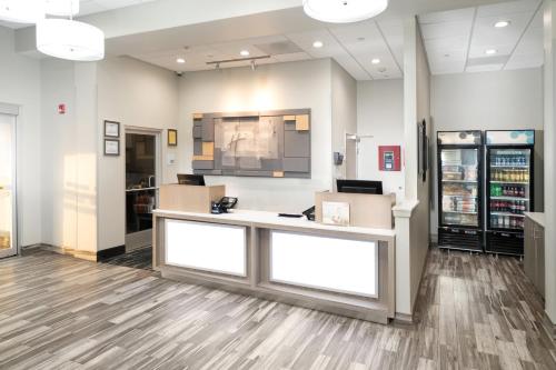 a waiting area in a store with a cashier counter at Holiday Inn Express & Suites Memphis Arpt Elvis Presley Blv by IHG in Memphis
