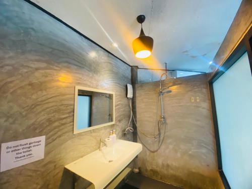 a bathroom with a sink and a shower at Family view A4 -Kantiang paradise resort- in Ko Bu Bu