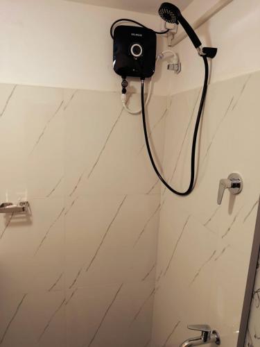 a bathroom with a shower with a camera on the wall at Mountain Bliss Villa Peradeniya in Peradeniya