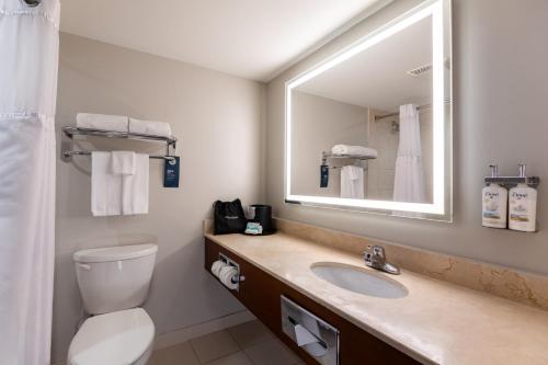 a bathroom with a sink and a mirror at Holiday Inn Hotel & Suites London by IHG in London