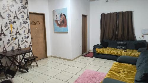 a living room with a couch and a table at Pousada RC Q3 in Várzea Grande