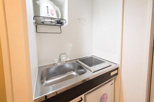 a kitchen with a sink and a stove at Osaka - Hotel / Vacation STAY 65254 in Osaka