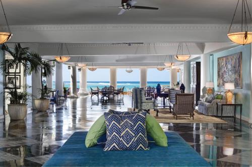 a lobby with a couch in the middle of a room at Half Moon in Montego Bay