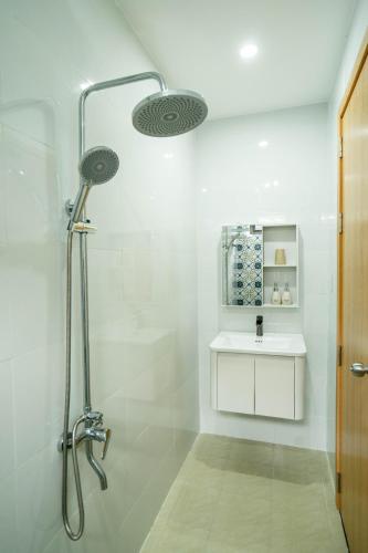 a bathroom with a shower and a sink at Dimori homestay in Hue
