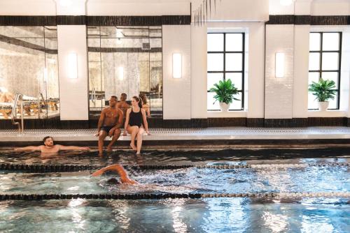 a group of people in a swimming pool at The Bellevue Hotel, in the Unbound Collection by Hyatt in Philadelphia