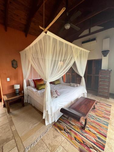 a bedroom with a bed with a canopy at Luxury Villa at Elements Golf Course - Bela Bela in Warmbaths