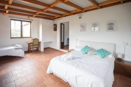 a bedroom with a large white bed and a table at Appartamenti Quintavalle in Casa Marchetti