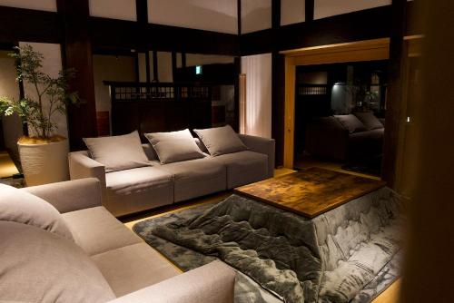 a living room with a couch and a fire pit at RICKA Katsuura in Katsuura
