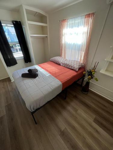 a small bed in a room with a window at Van Nuys Vibe in Van Nuys County Court Heliport