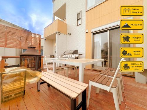 a patio with a table and benches and signs at ヴィラ山間堂 Terrace Villa BBQ Bonfire Fuji view Annovillas in Fujikawaguchiko