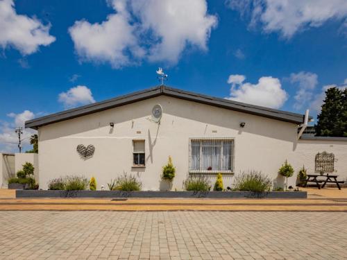 a white church with a cross on the roof at La Bella Vida Self Catering Apartments in Bellville